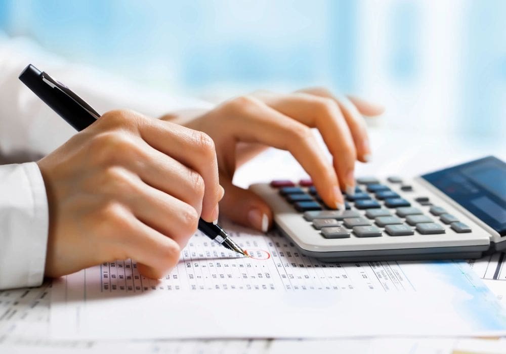 A person using a calculator to do their taxes.